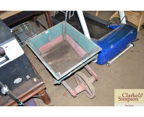 A Vintage green and red painted child's wheelbarrow with metal wheel