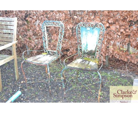 A pair of vintage ornate garden chairs AF