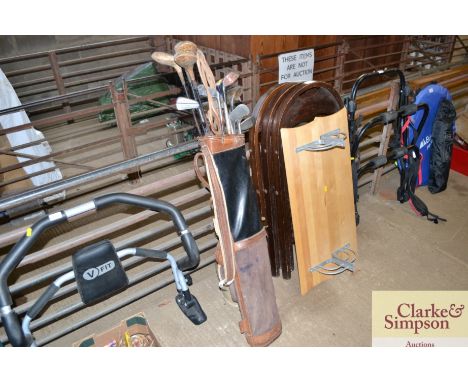 A vintage golf bag and contents of various vintage clubs to include a Rug Beater