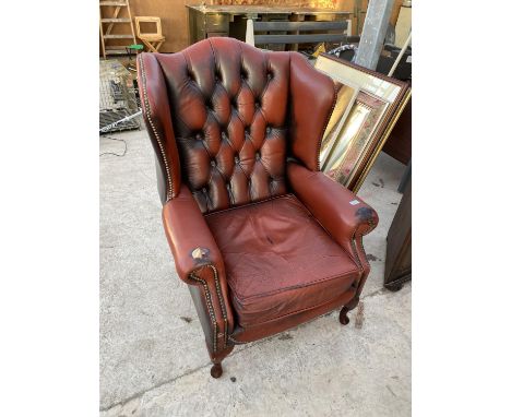 A LEATHER BUTTON AND WING BACK ARMCHAIR 