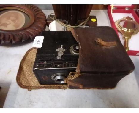 A VINTAGE CASED CAMERA 