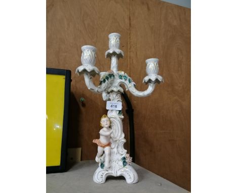 A CONTINENTAL HARD PASTE PORCELAIN FIGURAL CANDLESTICK 