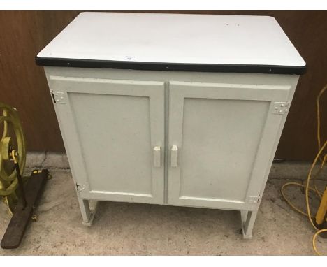 A TWO DOOR PAINTED CUPBOARD WITH INNER SHELVES AND AN ENAMEL TOP 77CM X 46CM 