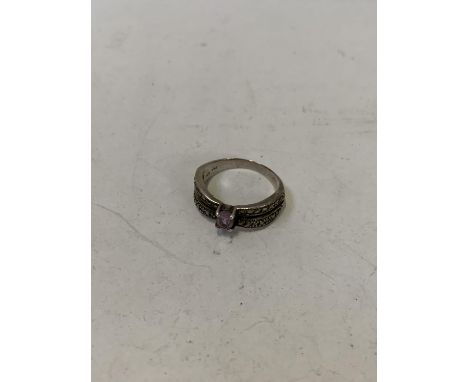 A LADIES RING WITH PRUPLE STONE DESGIN 