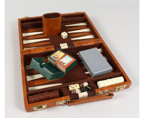 A LEATHER CASED BACKGAMMON SET.