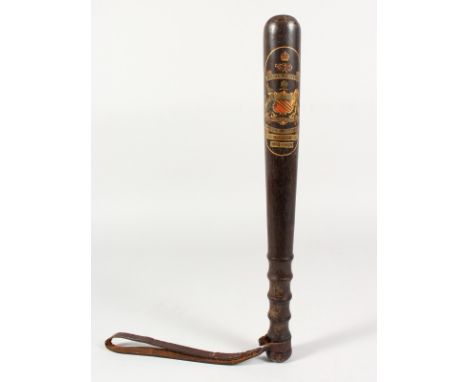 A TRUNCHEON - "MANCHESTER SPECIAL CONSTABLE P. LOMAS 1914-1919" with turned finger grip and leather strap. 15ins long.