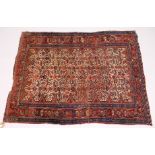 A PERSIAN RUG, early 20th Century, beige ground woven with stylized animals and birds, within a rust