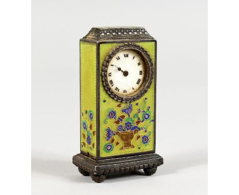 A MINIATURE SILVER CLOCK, with green ground enamel decorated body. 2.5ins high.