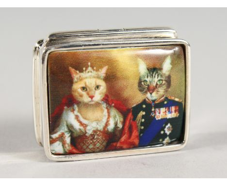 A SILVER BOOK SHAPED PILL BOX, the lid with an enamel of two cats.. 1ins diameter.