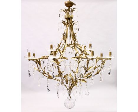 A LARGE AND IMPRESSIVE BRASS AND CUT GLASS TWELVE LIGHT CHANDELIER, with cut glass parts, prism drops abd leaf decorated arms