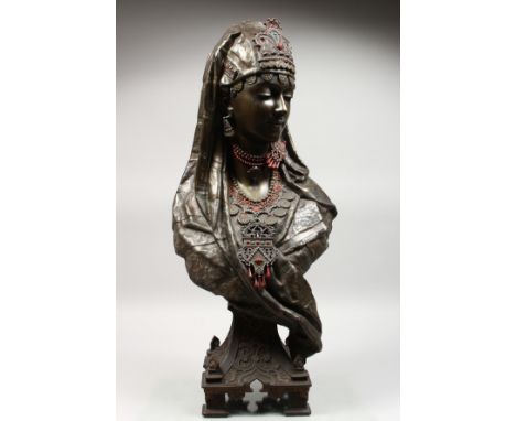 A SUPERB SPELTER BUST OF AN ARAB PRINCESS with head gear, drop earrings and enamel beadwork jewellery, on a square base with 