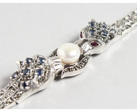 A GOOD SILVER AND SAPPHIRE PANTHER BRACELET with a large pearl.