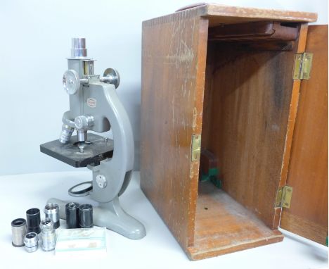 A cased Beck microscope, model no. 47 and a collection of microscope lenses 