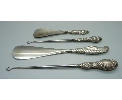 Four silver handled tools; two button hooks and two shoe horns 