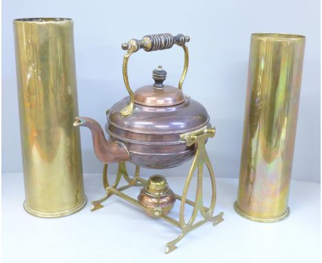 Two WWI brass shells and a copper spirit kettle on a brass stand 