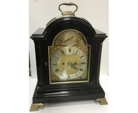 A 19th Century ebonised and brass cased dome top mantel clock on brass bracket feet, the eight movement twin fusee movement b