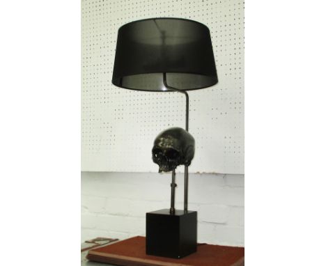 TABLE LAMP, of a skull in metal on square base with shade, 74cm H.