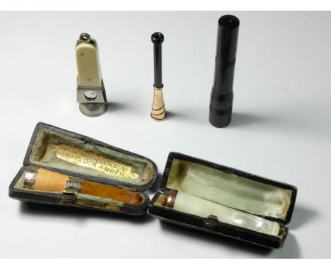 A 9ct gold mounted adjustable cigarette hold, Bakelite case, a mother of pearl cigarette holder, case, a silver mounted meers