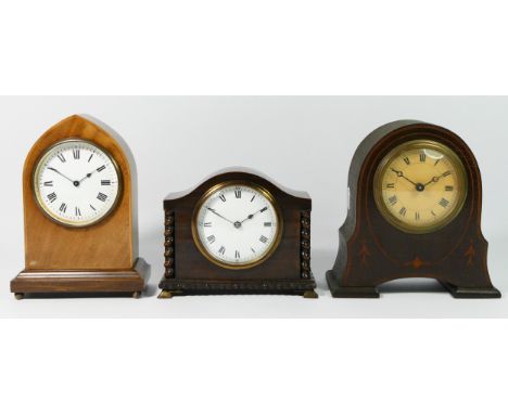 Three Edwardian mahogany &amp; oak cased mantel clocks, having enamelled dials with manual wind movements. (3)