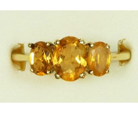 A 9ct gold and citrine three stone ring, R, 2.7gm 