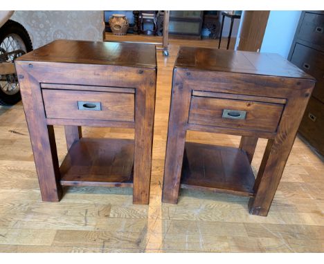 A pair of dark stained pine side tables, hidden pull out shelf over a single draw, above a lower shelf, brass handles, 50cm x