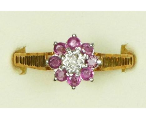 A 9ct gold ruby and diamond cluster ring, T, 1.6gm 