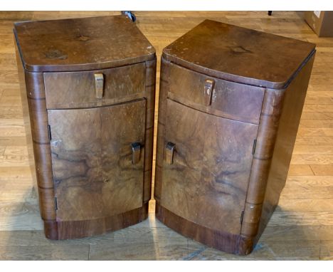 An Art Deco pair of walnut veneered bedside cabinets, bow fronted, single draw over a hinged door, opens to reveal a singled 