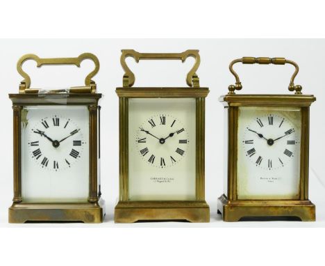 An early 20th century 8 day carriage clock, brass cased, bevel edged glass panels, enamelled dial, retailed by Garrard &amp; 