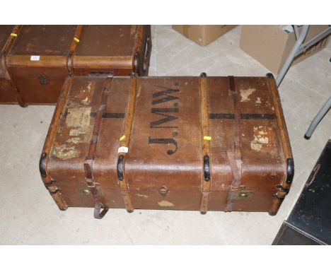 A vintage canvas and battened travelling trunk, initialed J.M.W. 