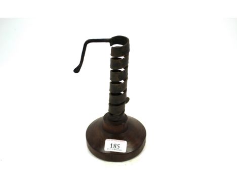 A 19th Century wrought iron spiral candlestick on fruitwood base 