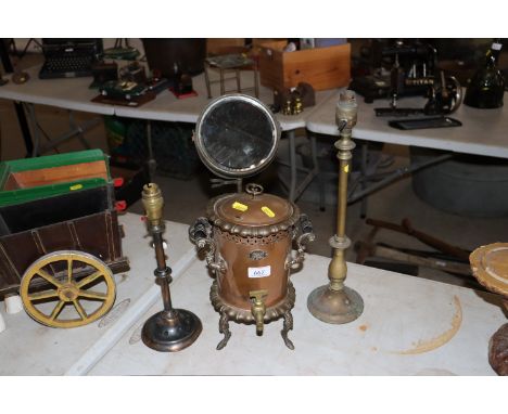 A copper and brass mounted tea urn, two brass lamps and a swing toilet mirror 