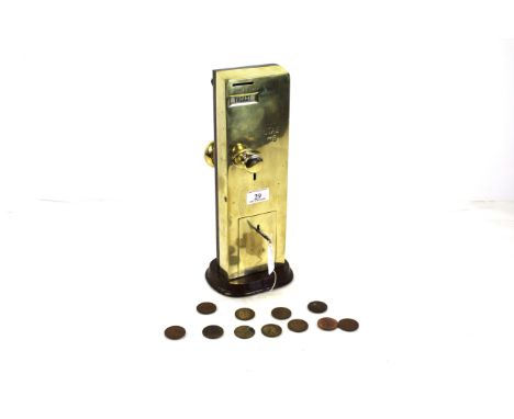 An early 20th Century brass Penny Toilet slot machine, compete with key and pennies