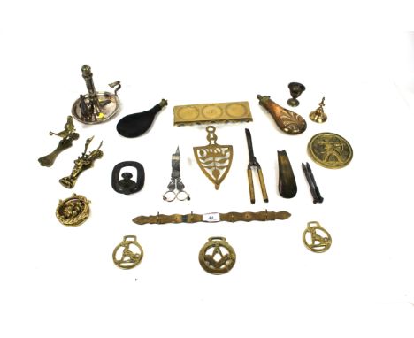 A collection of antique metal ware to include a plated chamber stick and snuffer, shot flasks, scissor action candle snuffers