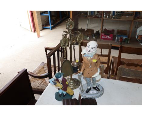 A vintage cast iron door stop in the form of Mr Micawber, a brass companion stand with horses head decoration, and a small ca