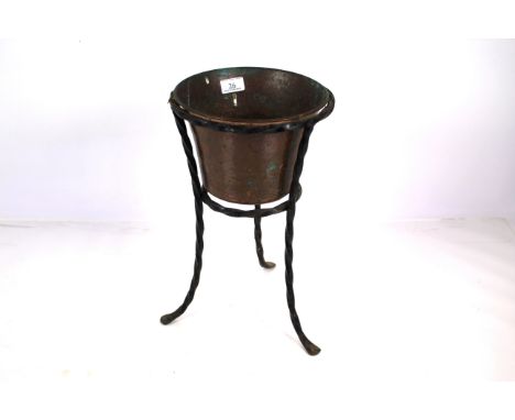 A copper planter in wrought metal spiral twist stand