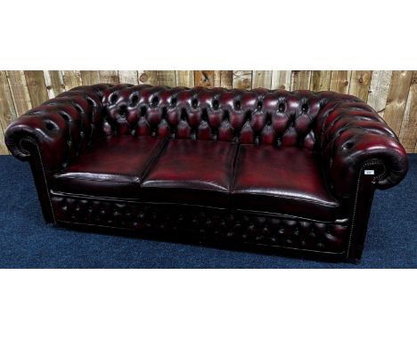 Three seat chesterfield sofa in ox- blood red leather. 74x204x92cm. 