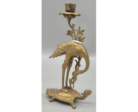 Antique Japanese Brass standing stock candlestick, standing on a turtle. 27cm high.