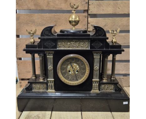 A Large and impressive 19th century Slate Mantel clock. Designed with raised relief brass places and columns. Also having a b