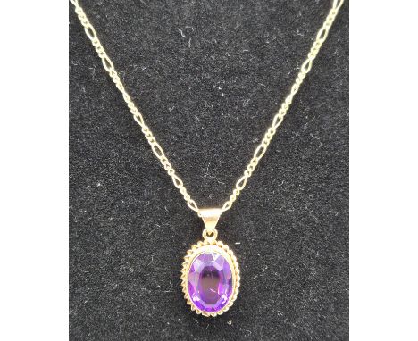 9ct yellow gold curb style necklace fitted with a 9ct yellow gold and oval cut Amethyst gem stone. 5.80grams. 45cm length. 