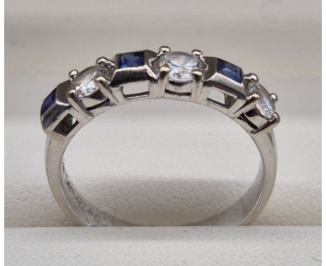 18ct white gold, sapphire and diamond stone ring. 0.60ct diamonds. Three Emerald cut sapphire gem stones. Ring size O. 4.30Gr