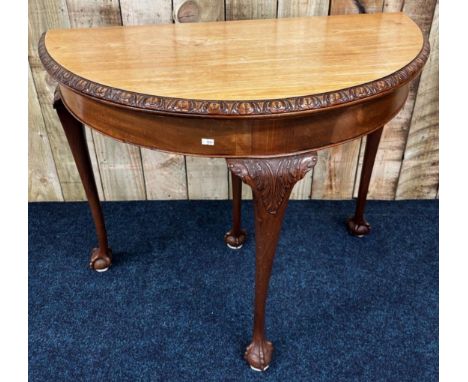 19th century mahogany demi lune card table. Fold over top revealing a green baize playing base. Circular form. Raised on Ball
