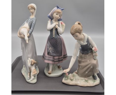 A collection of three Spanish Lladro porcelain figurines; Girl Attending the flowers, flower carrier &amp; girl carrying gees
