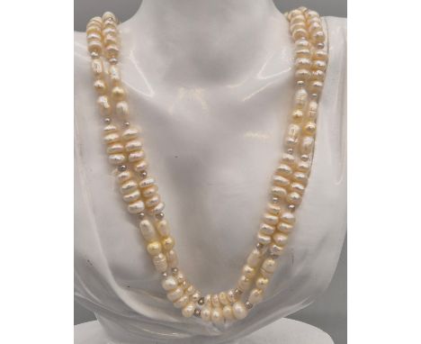 9ct yellow gold and two strand pearl necklace. 9ct yellow gold and seed pearl catch and clasp. Fitted with two strands of pea
