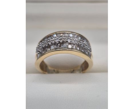 9ct yellow gold and diamond stone ring. 1ct diamonds. Round and Baguette cut diamonds. Ring size P. 5.68Grams. 