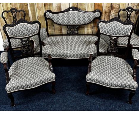A Late 19th century five piece parlour sofa set. Two seat sofa with arm rests, Two single arm chairs and two chairs. All havi