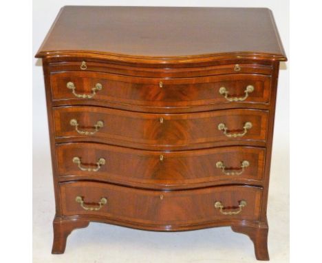 A good quality reproduction serpentine fronted chest of four drawersOf small proportions, having dressing slide, raised on br