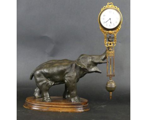 A 19th Century Elephant clockModelled in the form of a spelter elephant, the trunk holding a gilt metal pendulum type clock, 