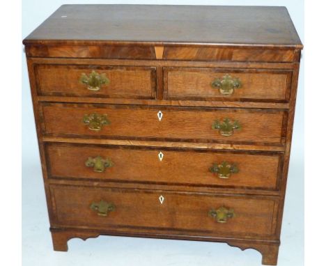 A Georgian oak straight front chest Having two short over three long drawers, raised on bracket feet, height 95.5cm, width 96