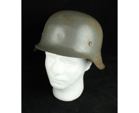 A Swedish M40 type Infantry helmet, mid 20th CenturyGrey painted helmet with leather lining marked with C F below a Swedish c