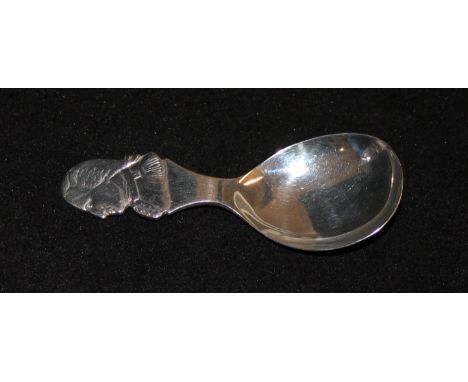 A novelty silver caddy spoonThe handle depicting the profile of George Washington, by Thomas Bradbury & Sons Ltd., Sheffield 